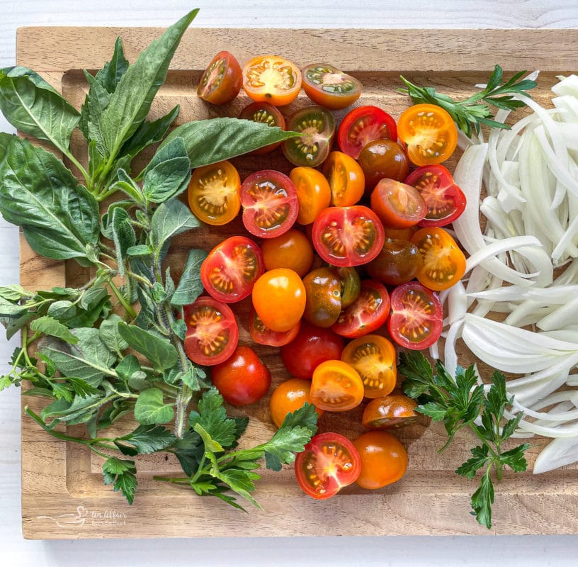 basil, tomatoes, and onions on wooden cutting board