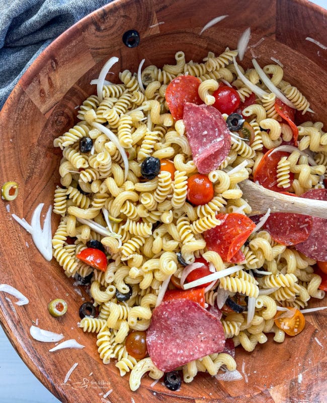 Top view of antipasto pasta salad in wooden bowl