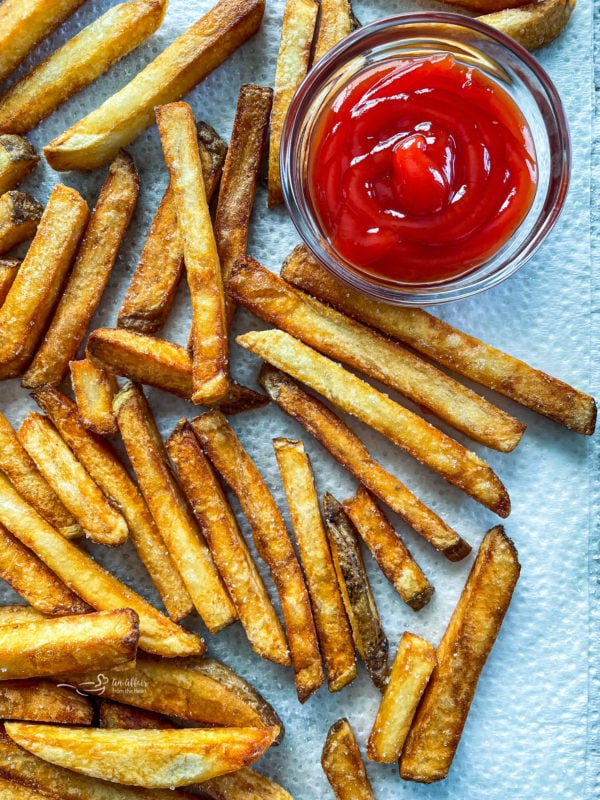 Close view of double fried french fries with ketchup