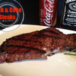 Close up of Jack & Coke Steak on a white plate with text "Jack & Coke Steaks"