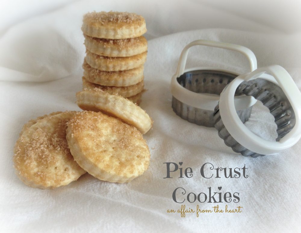 pie crust cookies and cookie cutters on a white cloth