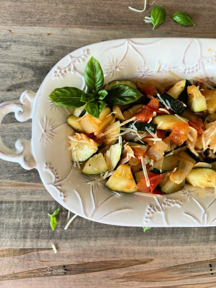 Zucchini & Tomatoes in a white decorative serving plate.