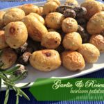 garlic & rosemary heirloom potatoes on a white serving platter