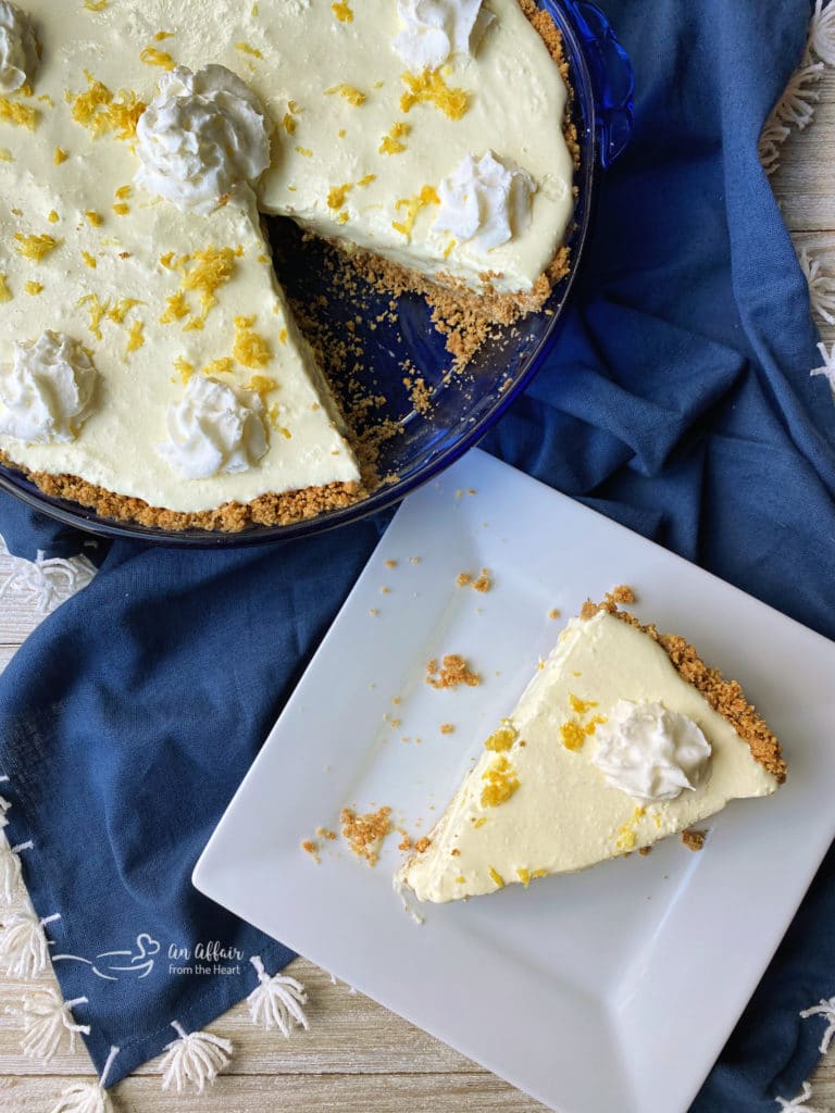 Overhead of whole pie and a slice on a white plate