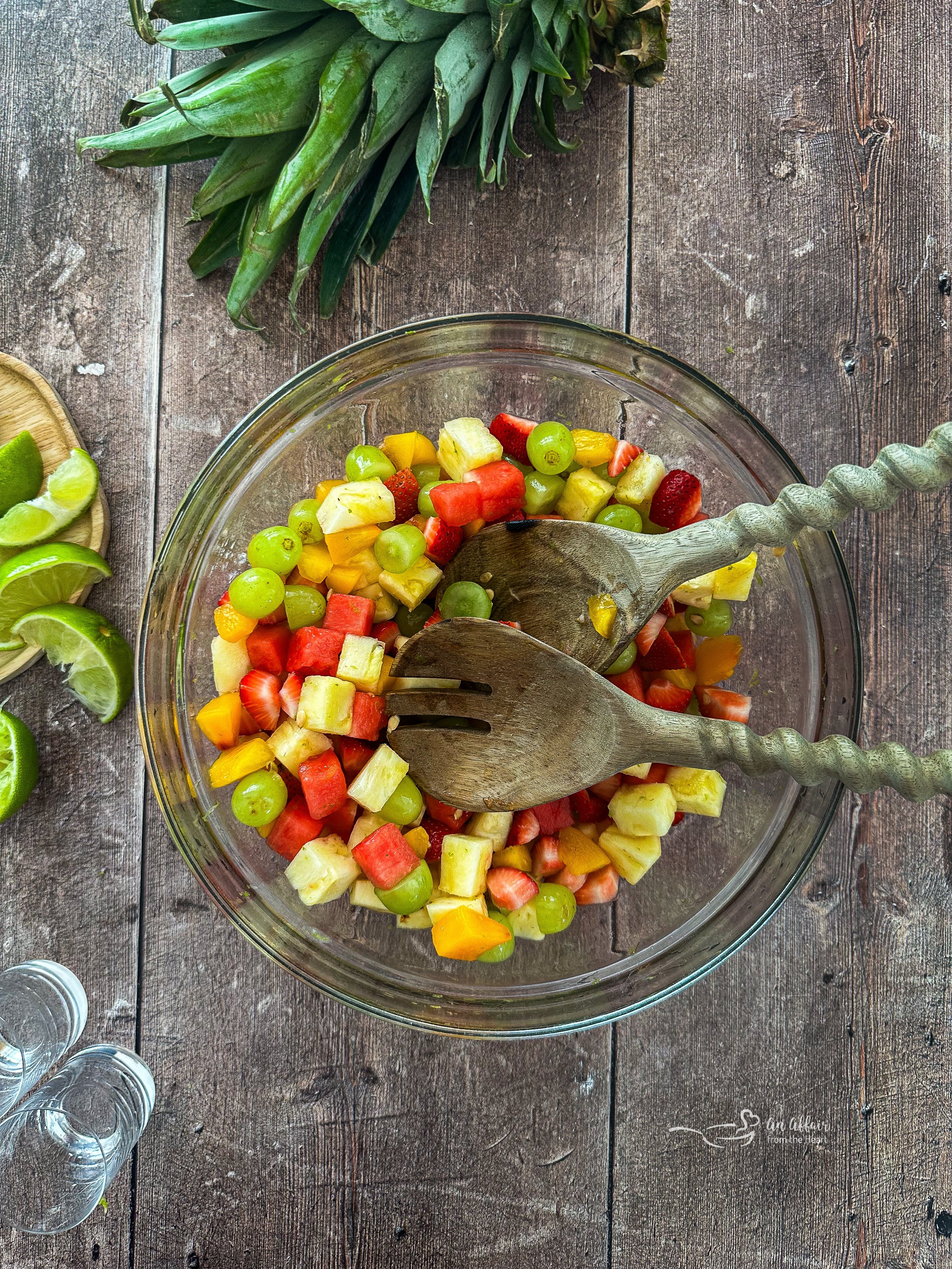 Margarita Fruit Salad in a bowl with salad spoons.