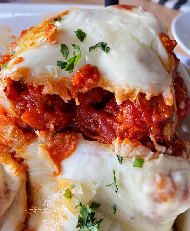 close view of chicken parmesan with cheese and tomato sauce
