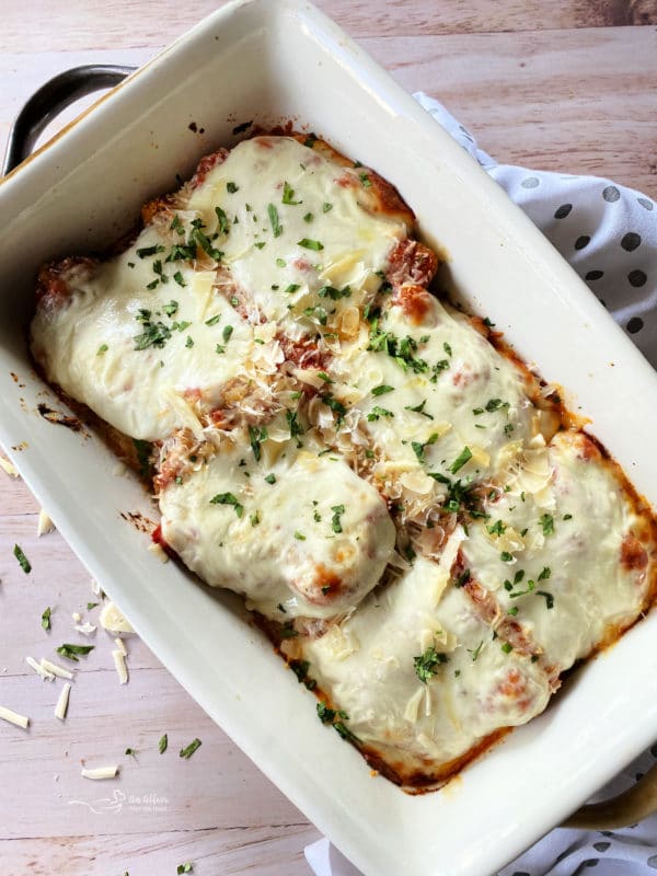 top view of cheesy chicken parmesan in white dish