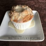 Bread Pudding Soufflé with Whiskey Sauce on a white plate