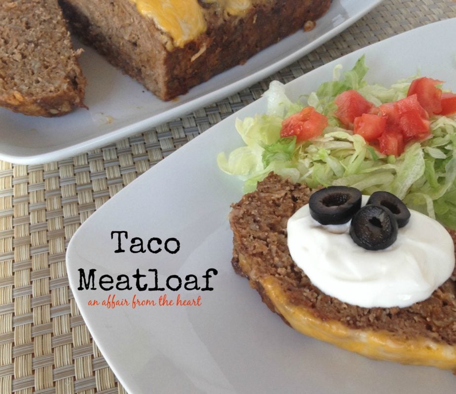 taco meatloaf with toppings and a side salad on a white plate