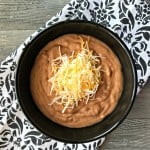 Overhead of Restaurant Style Refried Beans in a black bowl