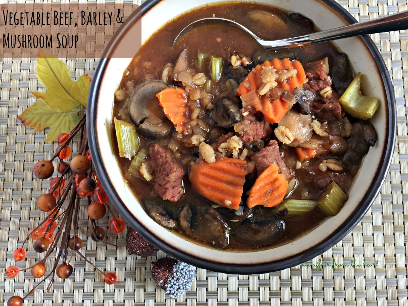 Overhead of soup in a black bowl with text "Vegetable Beef, Barley & Mushroom Soup"
