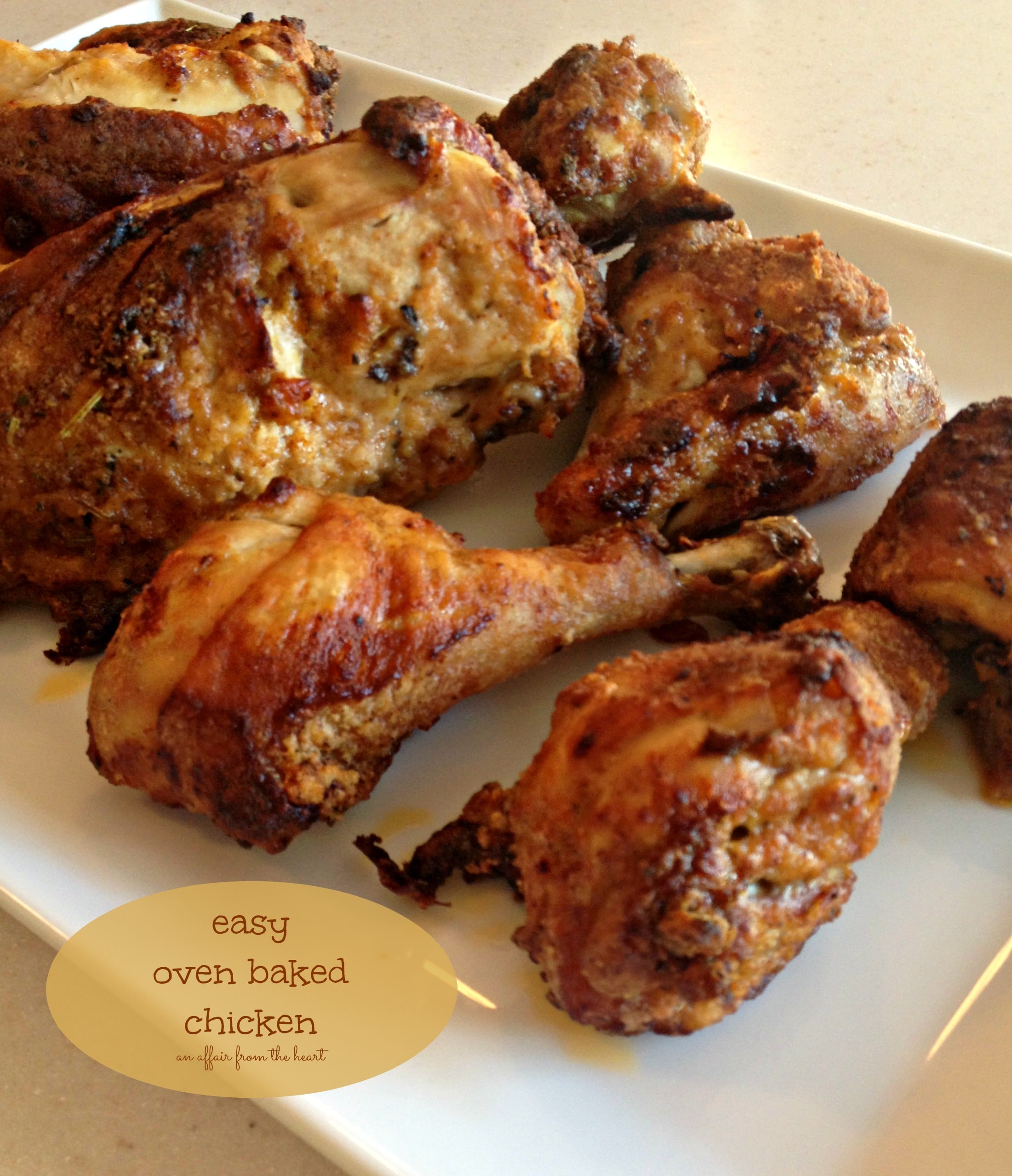 Chicken on a white platter with text "Easy oven baked chicken"