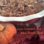 French toast bake in a red casserole dish with text "pumpkin cinnamon swirl baked french toast"