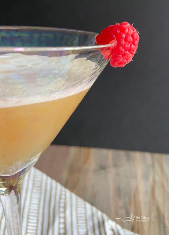 close up of a French martini with a raspberry on the rim