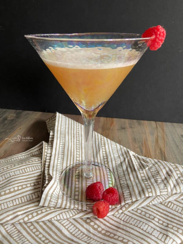 Martini glass filled with French martini cocktail and garnished with a raspberry