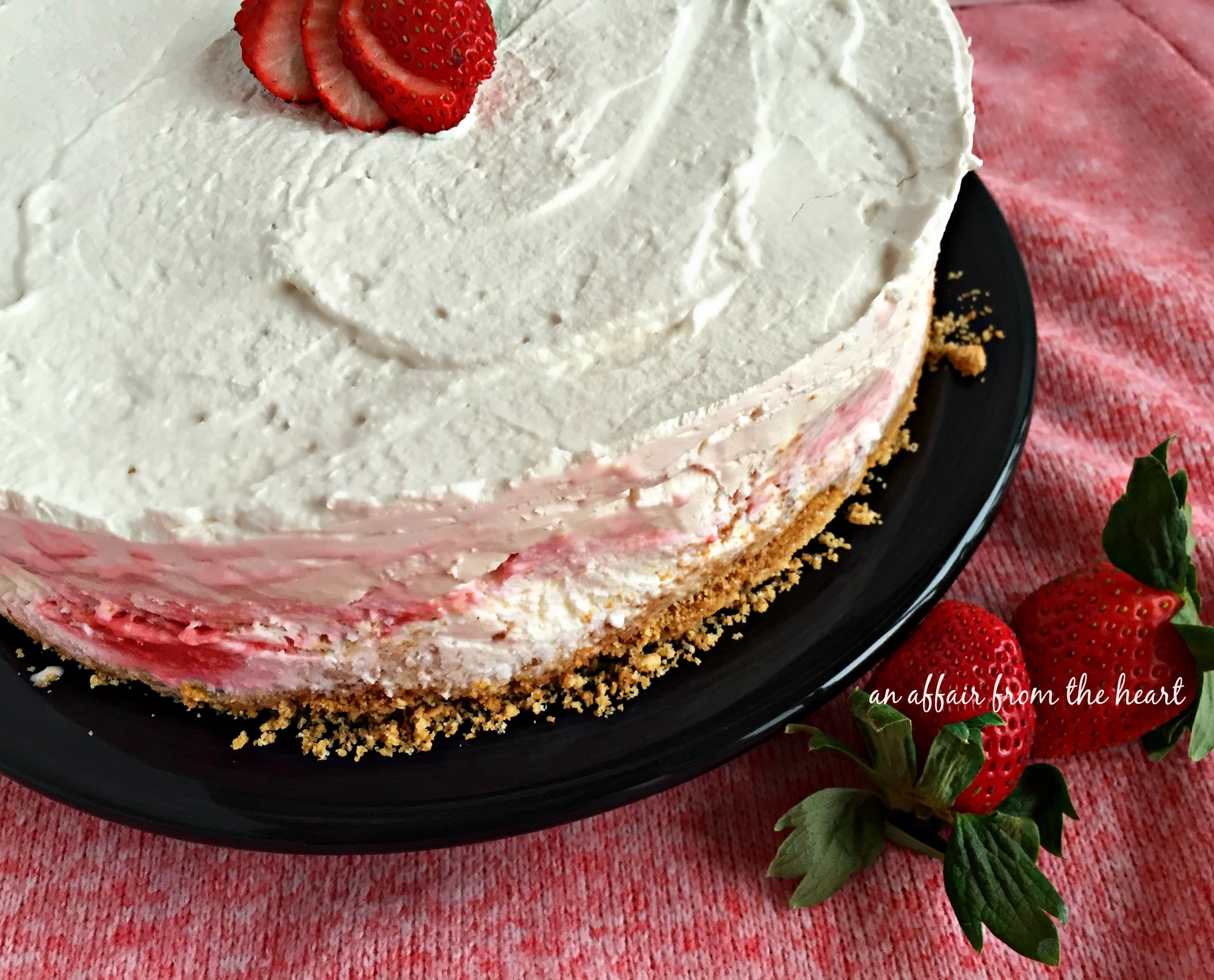 Strawberry Cheesecake Ice Cream Torte on a black plate