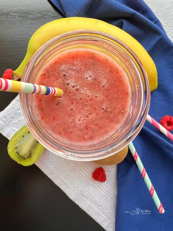 fiber smoothie, banana and straws on blue and white napkins.