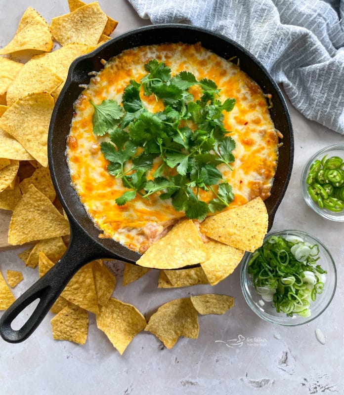 Mexican bean dip with tortilla chips on top