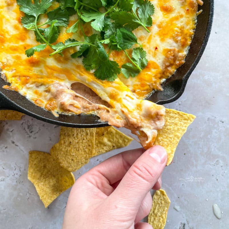 dipping chips in bean dip