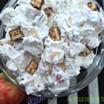 Close up of snicker apple salad in a clear bowl