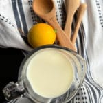 Buttermilk Substitute image with milk and lemon and measuring spoons