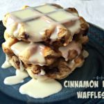 Waffles stacked on a blue plate with text 'Cinnamon Roll Waffles"