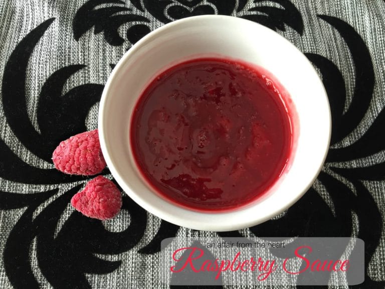 overhead of raspberry sauce in a white cup