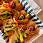 Italian Sausage with Peppers & Onions lined upon a decorative plate
