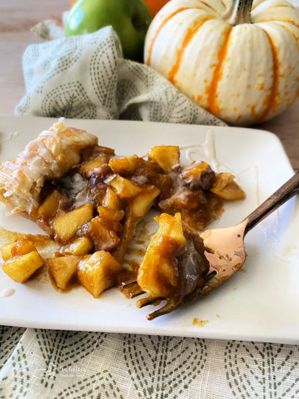 apple pumpkin strudel on white plate with fork 