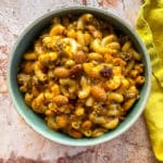 Chili Mac in a bowl with a yellow napkin along the side