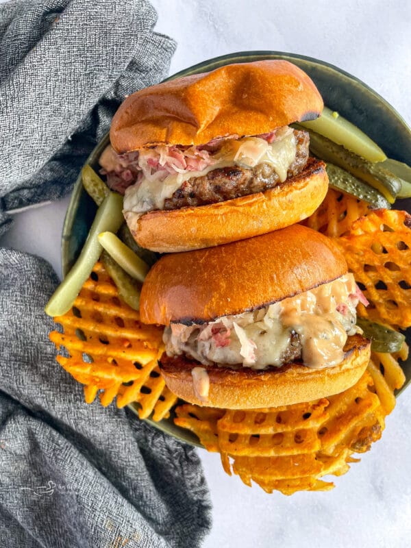 Reuben Burgers on Plate with Sweet Potato Waffle Fries