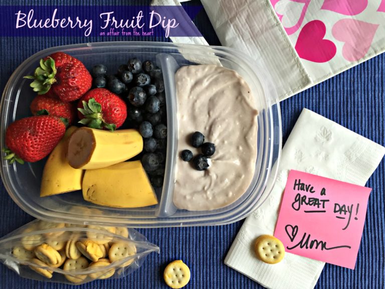 blueberry fruit dip and a variety of fruits in a container with text "blueberry fruit dip"