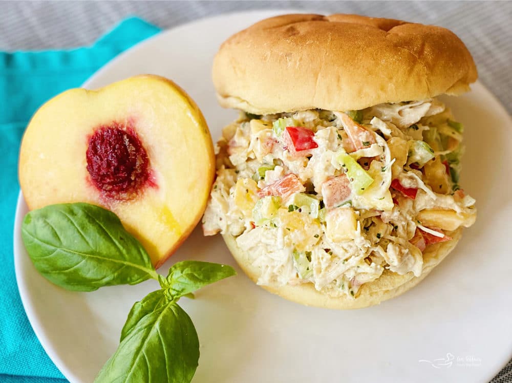 top view of chicken salad on bun with peach