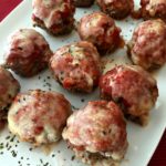 mini meatloaves on a white platter with text "Pizza Meatloaf Minis"