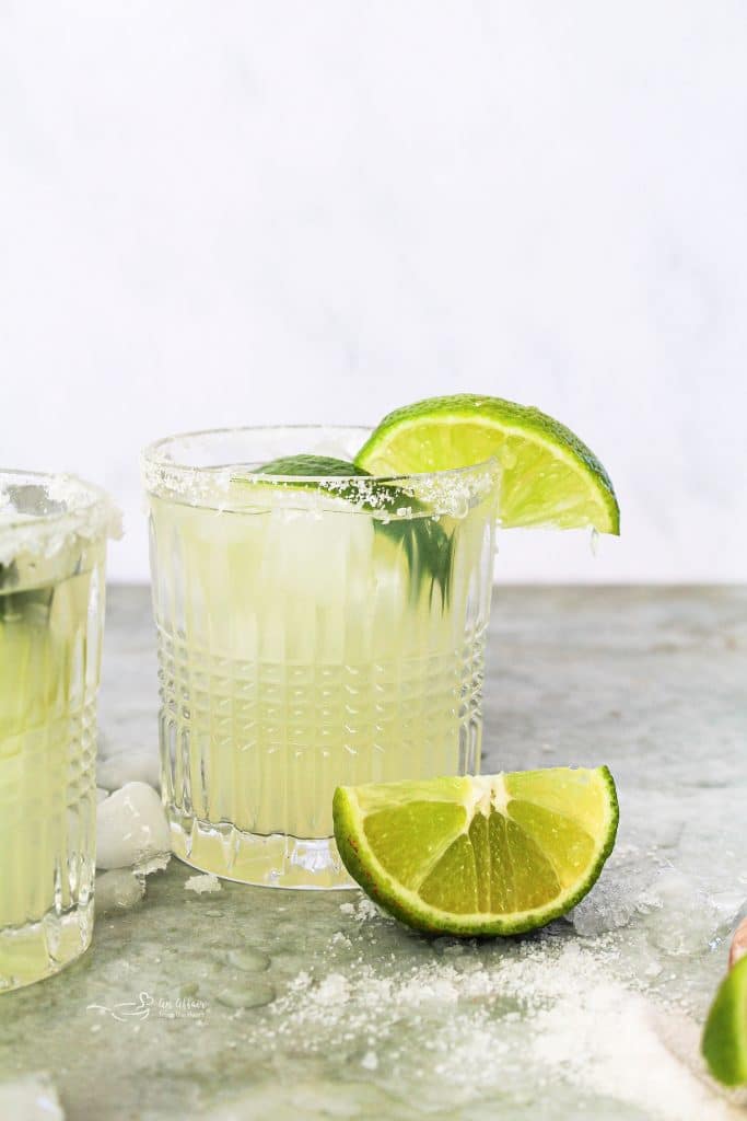 A Margarita garnished with limes.