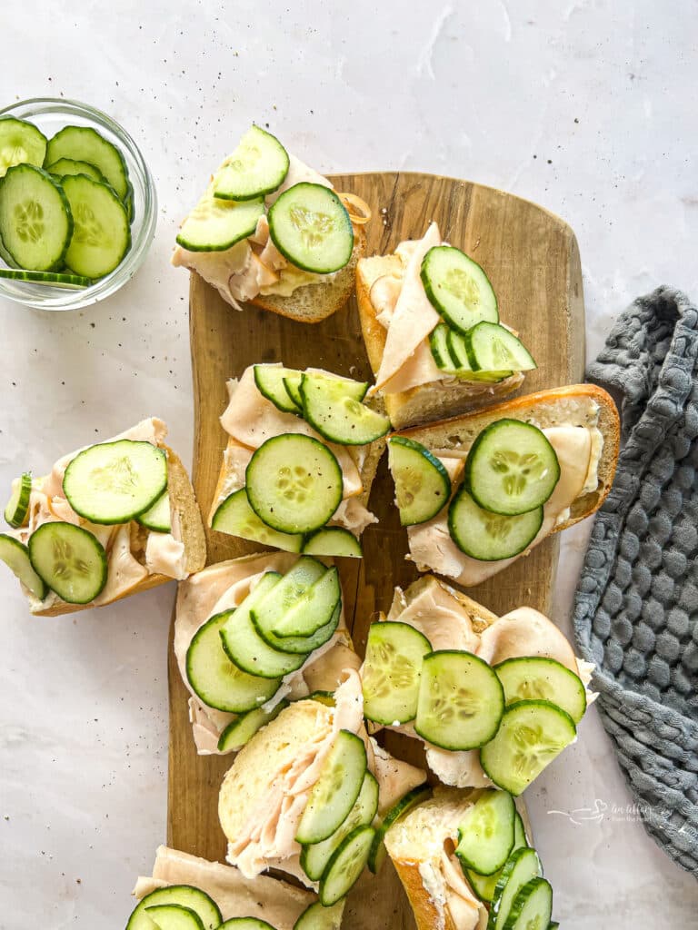 Sliced turkey ranch baguettes on a wood board