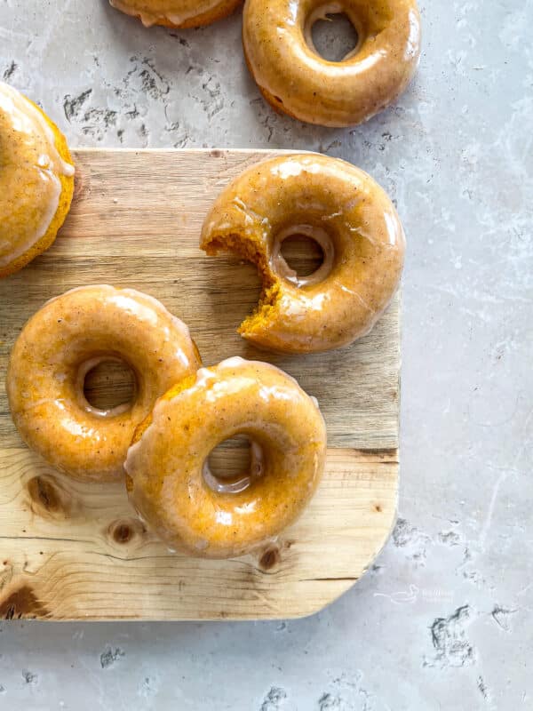 Glazed Baked Pumpkin Donuts with bite taken out