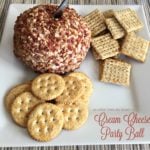 Close up of Cream Cheese Party Ball and crackers on a white plate