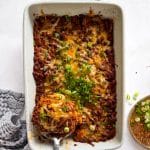 Serving Bubble Up Enchiladas with a large serving spoon.