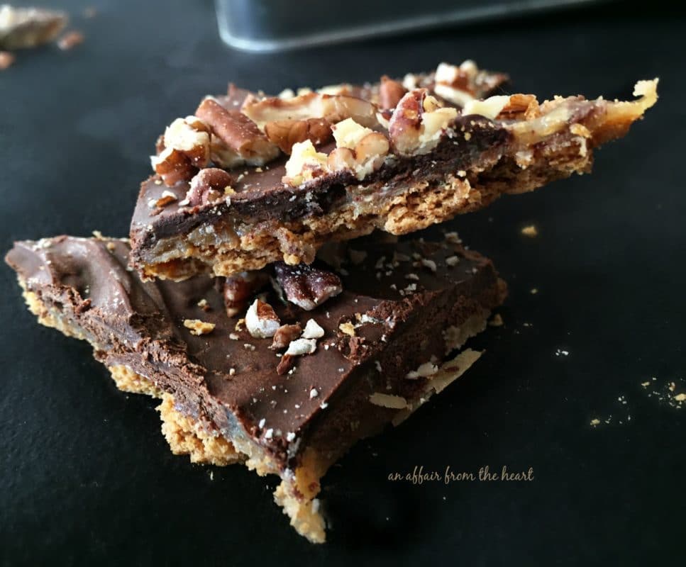 Close up of Graham Cracker Toffee stacked on a black plate