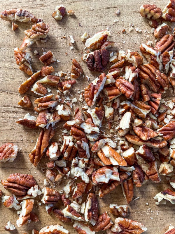 chopped pecans on wooden surface