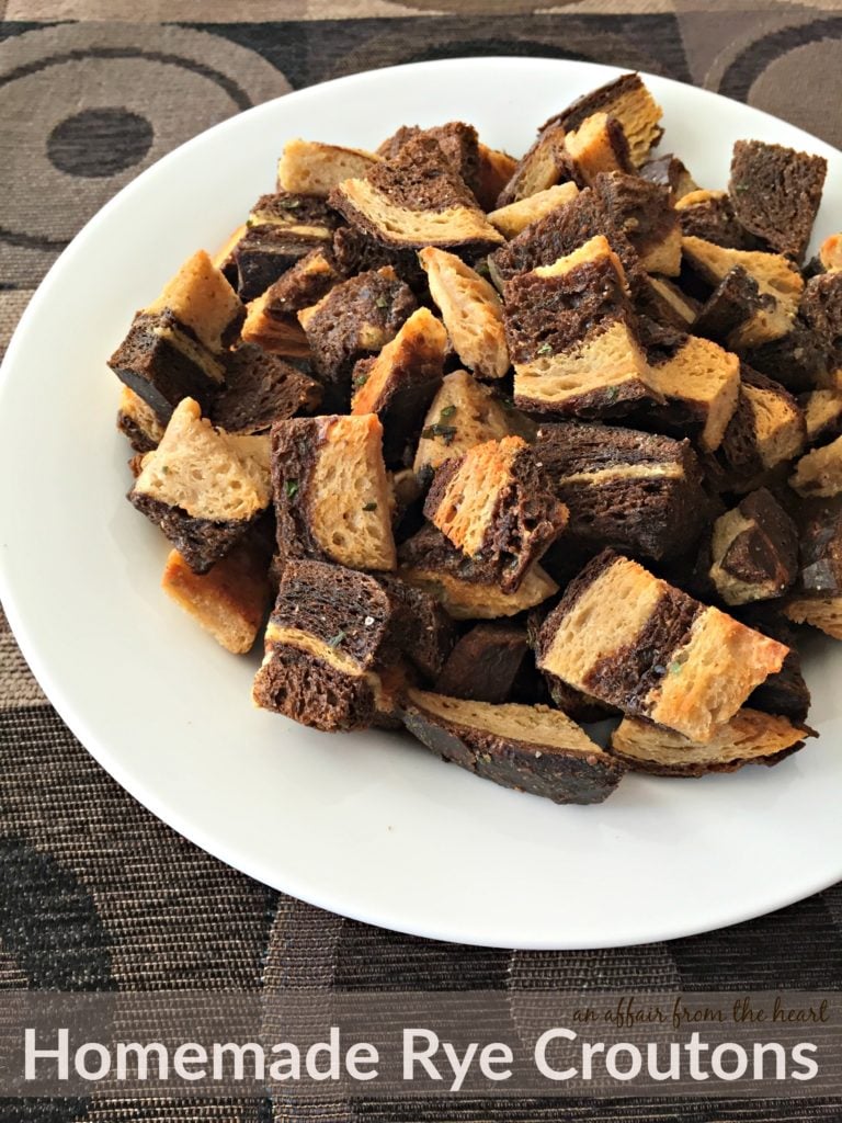 Rye Croutons on a white plate with text "Homemade Rye Croutons"