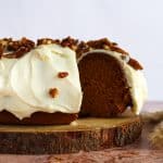 Pumpkin Bundt Cake with Cream Cheese Frosting (Cinderella Cake) on a wooden serving plate