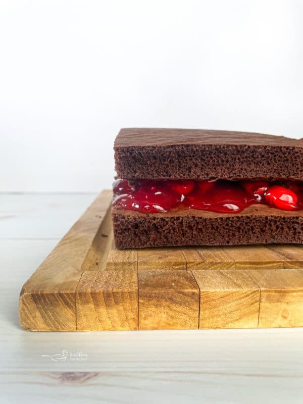 cherry pie filling in between two chocolate cake layers