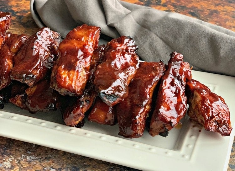 Close up of Slow Cooker Dr. Pepper BBQ Ribs on a white serving plate