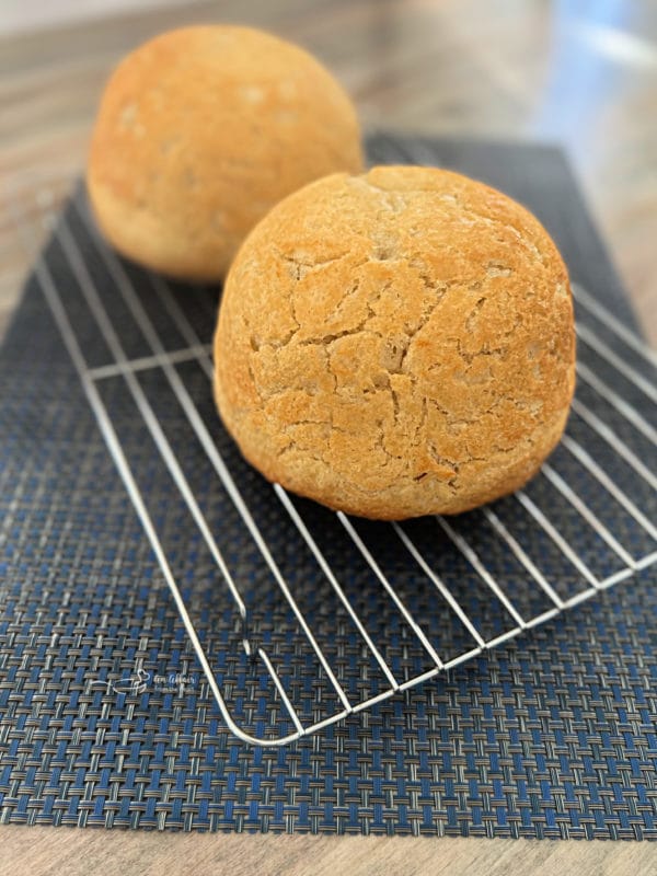 two loaves of peasant bread cooling on wire rack