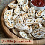Tortilla Pinwheels on a wooden serving tray with text "tortilla pinwheels"