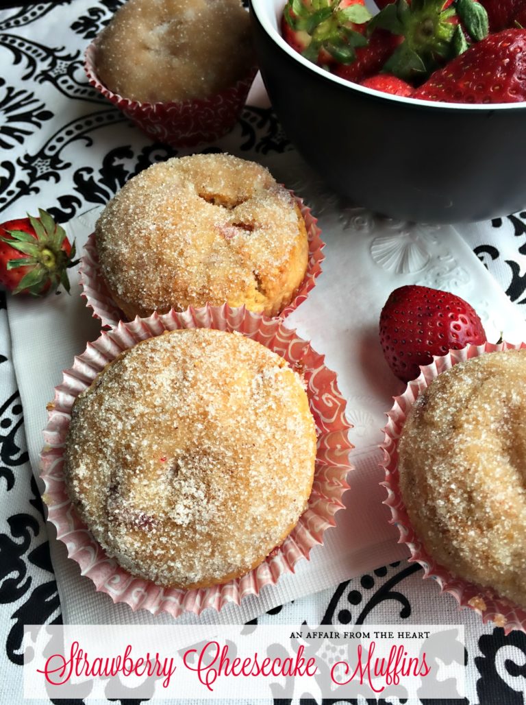 close up of muffins with text "Strawberry Cheesecake Muffins"