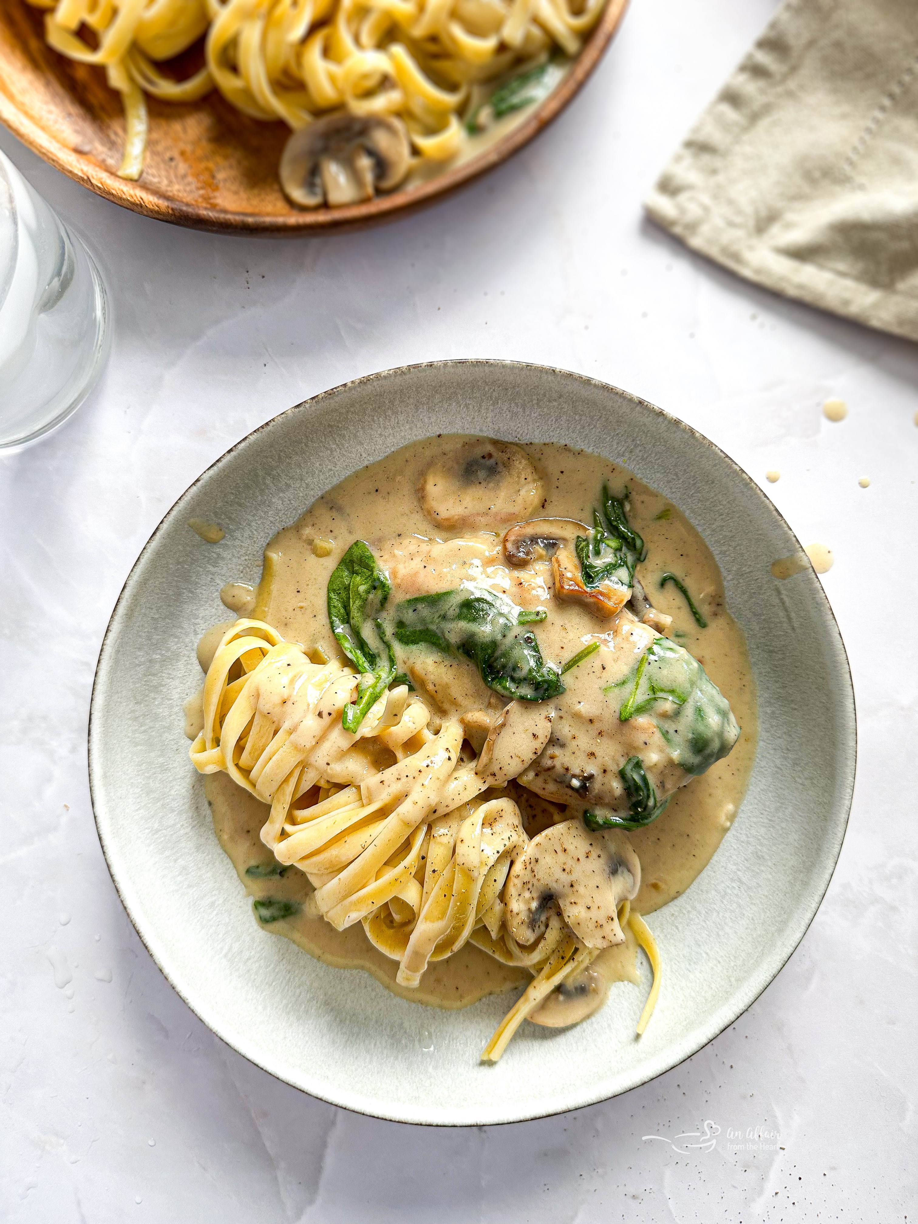 Overhead of Chicken Mushroom Florentine pasta on a white plate