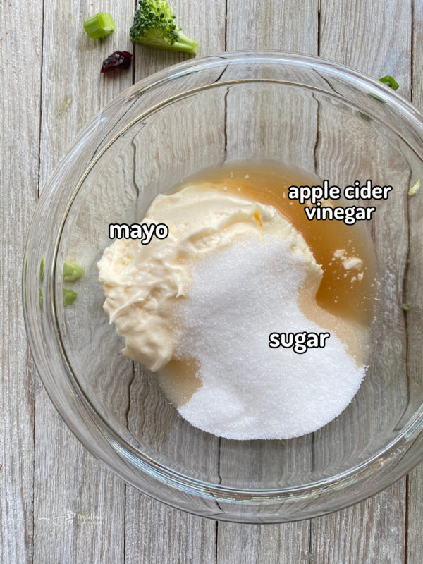 Top view of mayonnaise, sugar, and apple cider vinegar in bowl
